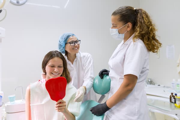 teenager girl in dental chair with mirror looking 2022 01 13 23 00 36 utc 1