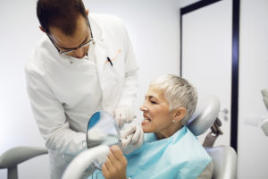 dentist checking woman s teeth at clinic 2022 03 09 02 09 53 utc 1