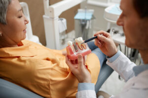 closeup of male dentist explaining dental implant 2023 06 07 17 20 22 utc 1